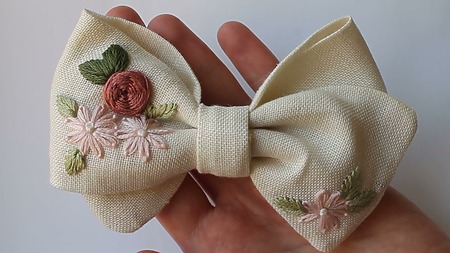 fabric bow with hand embroidered flowers