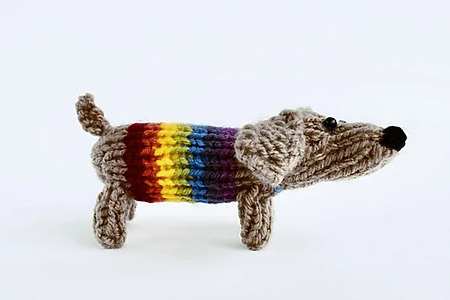 DIY knitted sausage dog resembling a dog wearing a rainbow sweater