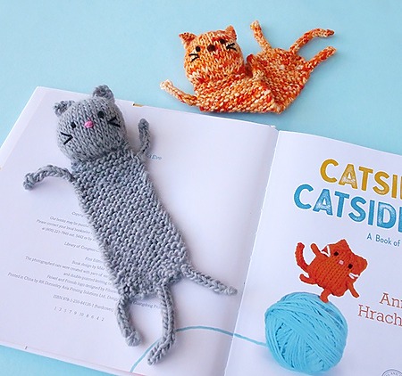 cute knitted cat bookmark with a flat garter stitch body, stuffed head and I-cord paws
