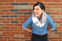 young woman laughing and wearing a simple garter stitch knitted cowl