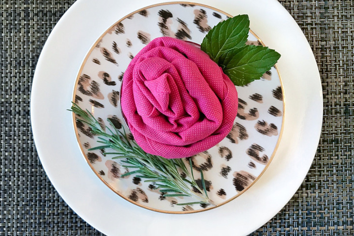 cloth napkin folded into the shape of a rose flower