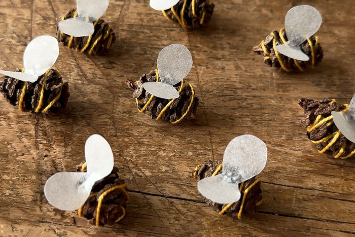 creative DIY bee Valentine's using pinecones, embroidery floss and paper wings