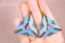 DIY triangle beaded earrings that feature a geometric triangle design accented with sparkling bicone beads