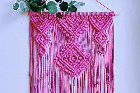 DIY macrame wall hanging tutorial with geometric diamonds, square knots, and bright pink cord
