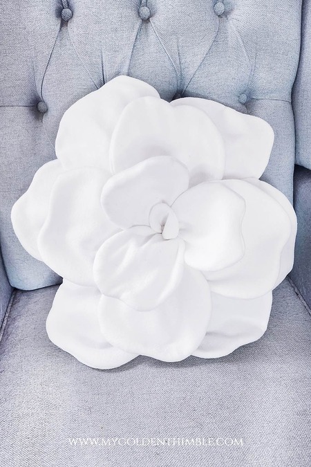 Rose Pillow: A textured fabric throw pillow with layers of swirling fabric that mimic the look of a blooming rose