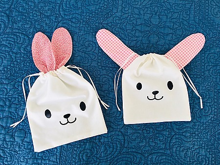 Seam Whisperer Bag: A cotton drawstring bag with fabric bunny ears peeking out from the drawstring closure