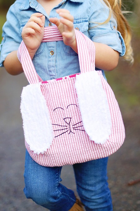 Sew Much Ado Bag: A small fabric bag with upright bunny ears on the front and a white pom-pom tail on the back