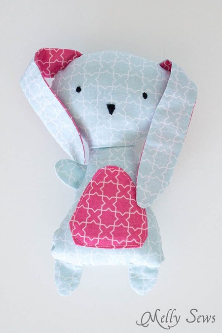 Melly Sews Bunny: A soft, lightly stuffed fabric bunny made from colorful scrap fabrics with long floppy ears
