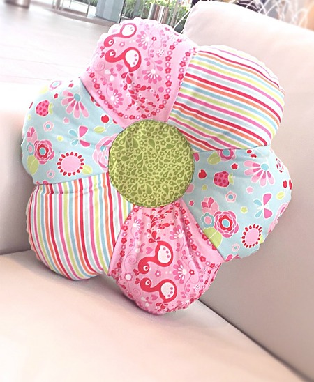 Flower Shaped Pillow: A large, plush decorative throw pillow sewn in the shape of a multi-petal blossom