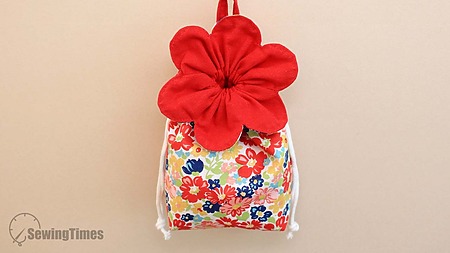 Flower Pouch Bag: A handmade drawstring pouch shaped like a blooming flower with fabric petals and a cord closure