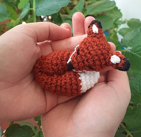 Wizard the Little Sleeping Fox: A small crocheted sleeping fox with its head resting down and its tail curled gently around its body